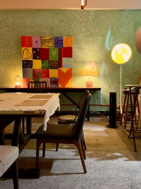 A cozy corner with warm neutral-toned abstract wall art softly lit, inviting calm and conversation.