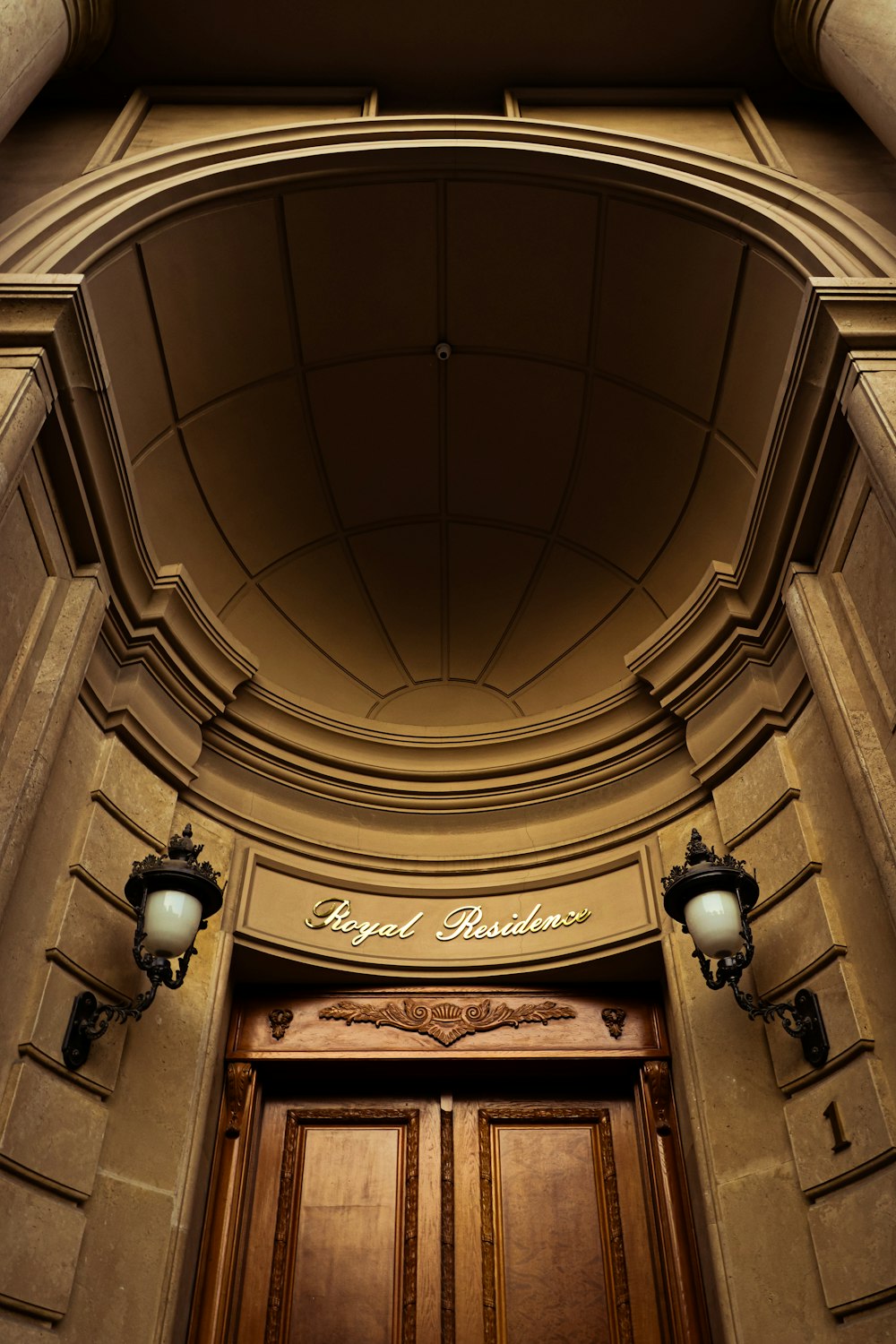 a building with a large wooden door and two lights