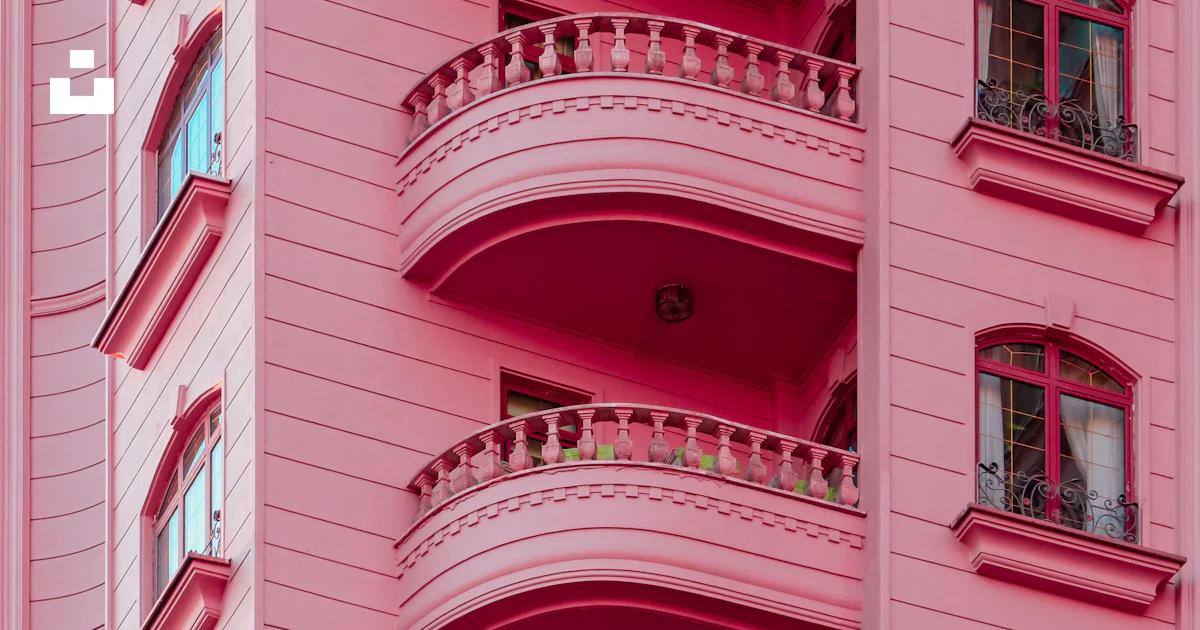 A pink building with balconies and balconies on the balconies photo ...