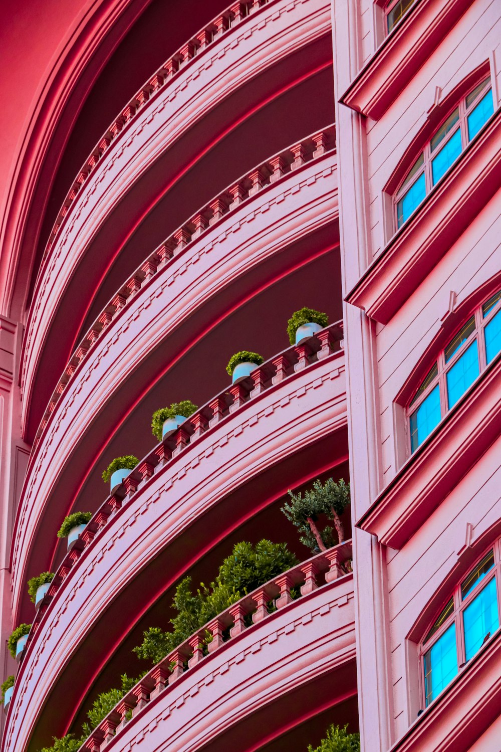 a pink building with balconies and balconies on the balconies