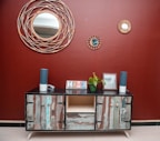 A rustic wooden sideboard buffet with decorative items on top in a warm dining space.
