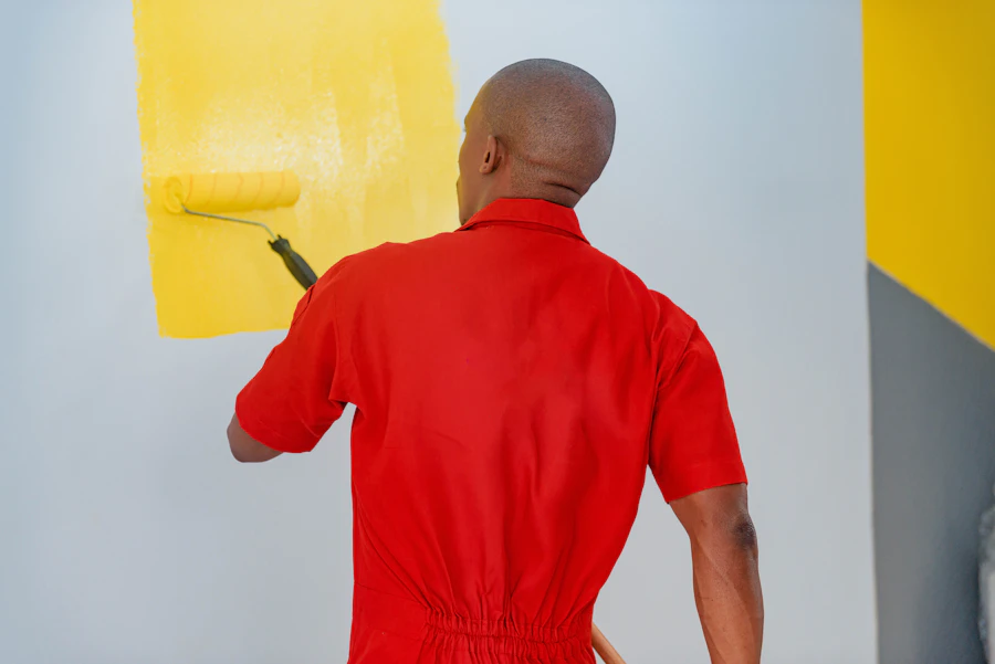 Professional painter applying paint to an interior wall