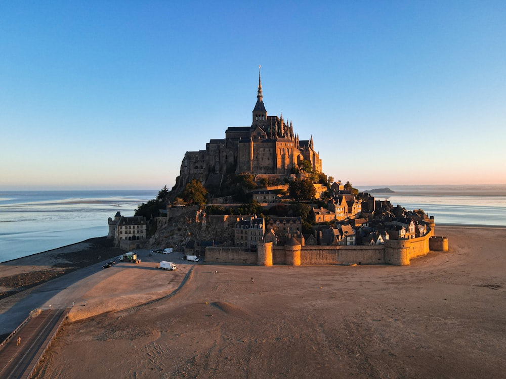 a very large castle sitting on top of a sandy beach
