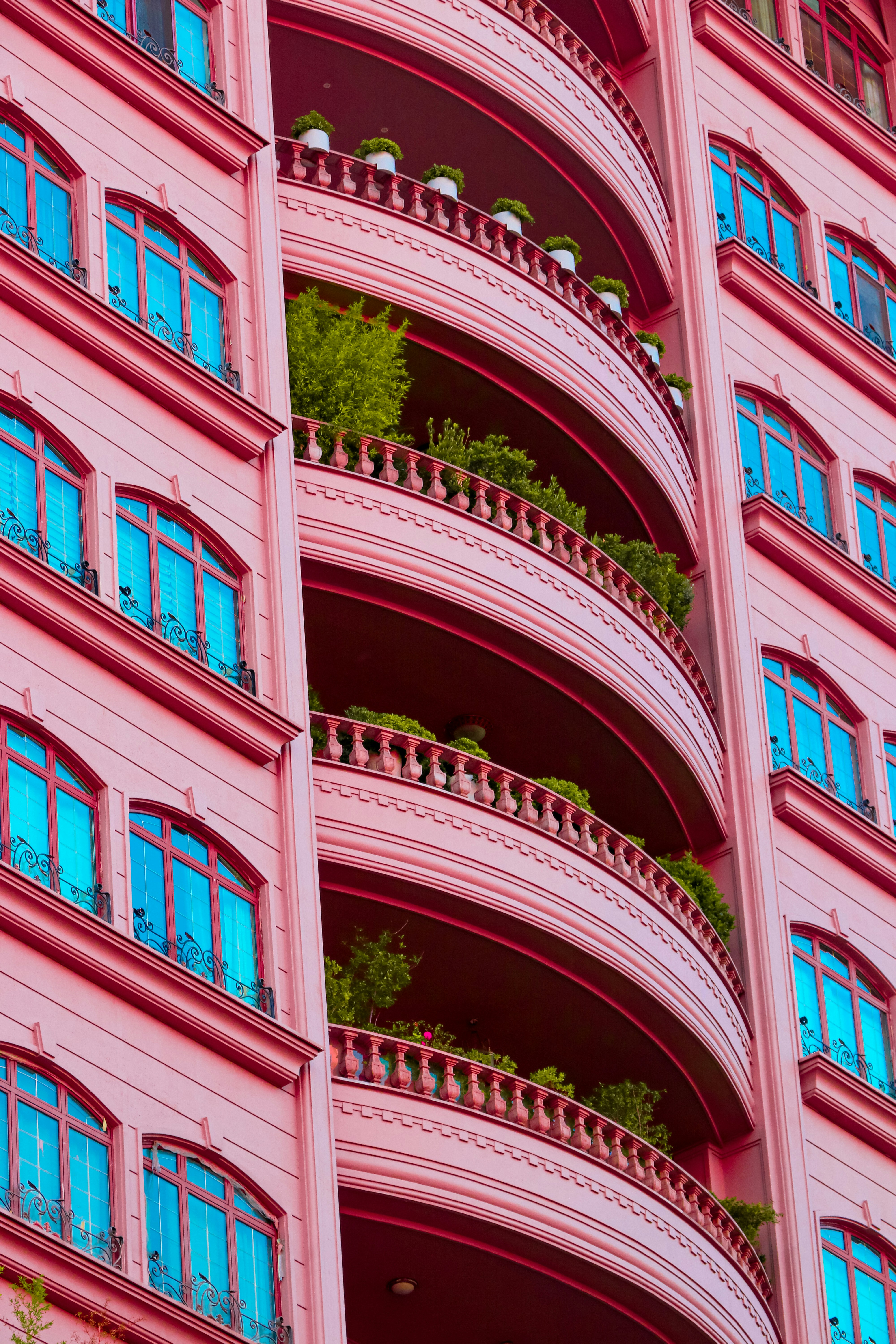 A pink building with balconies and balconies on the balconies photo ...