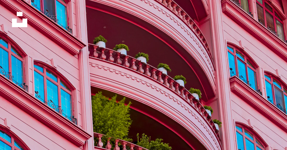 A pink building with balconies and balconies on the balconies photo ...