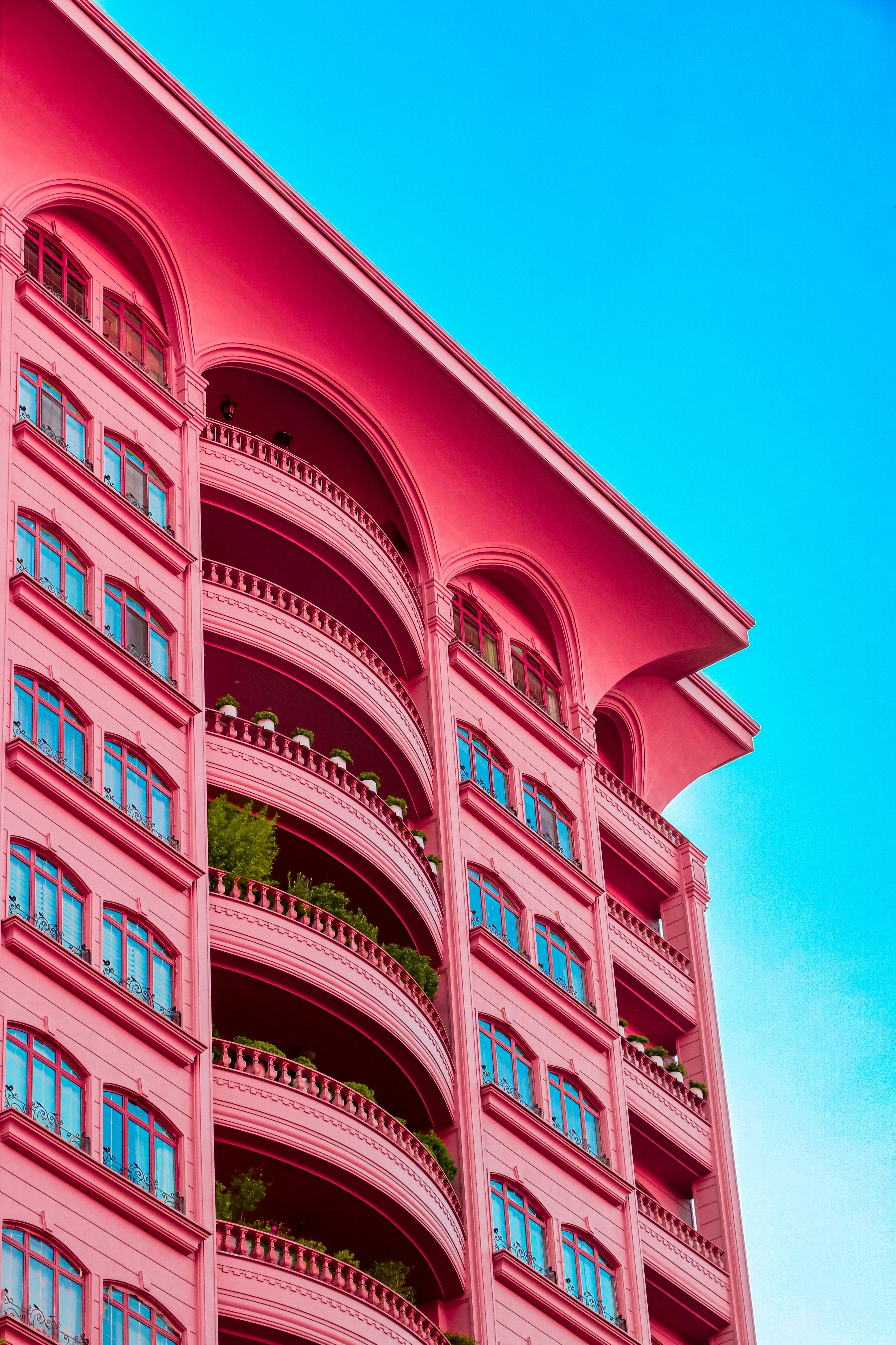 A pink building with balconies and balconies on the balconies photo ...