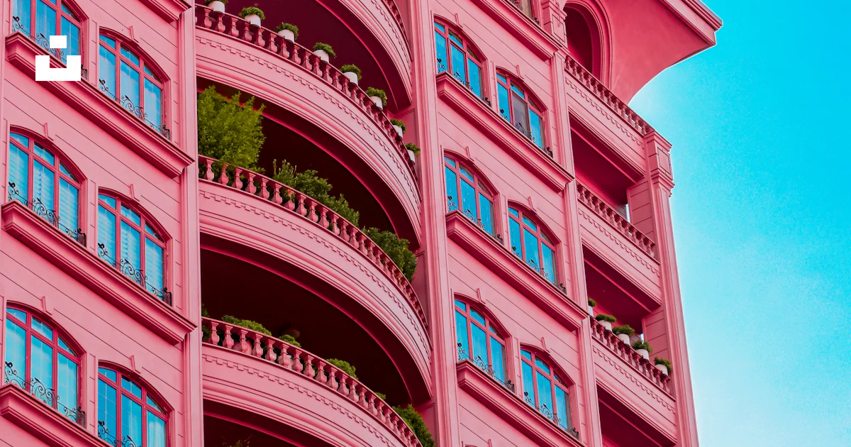 A pink building with balconies and balconies on the balconies photo ...