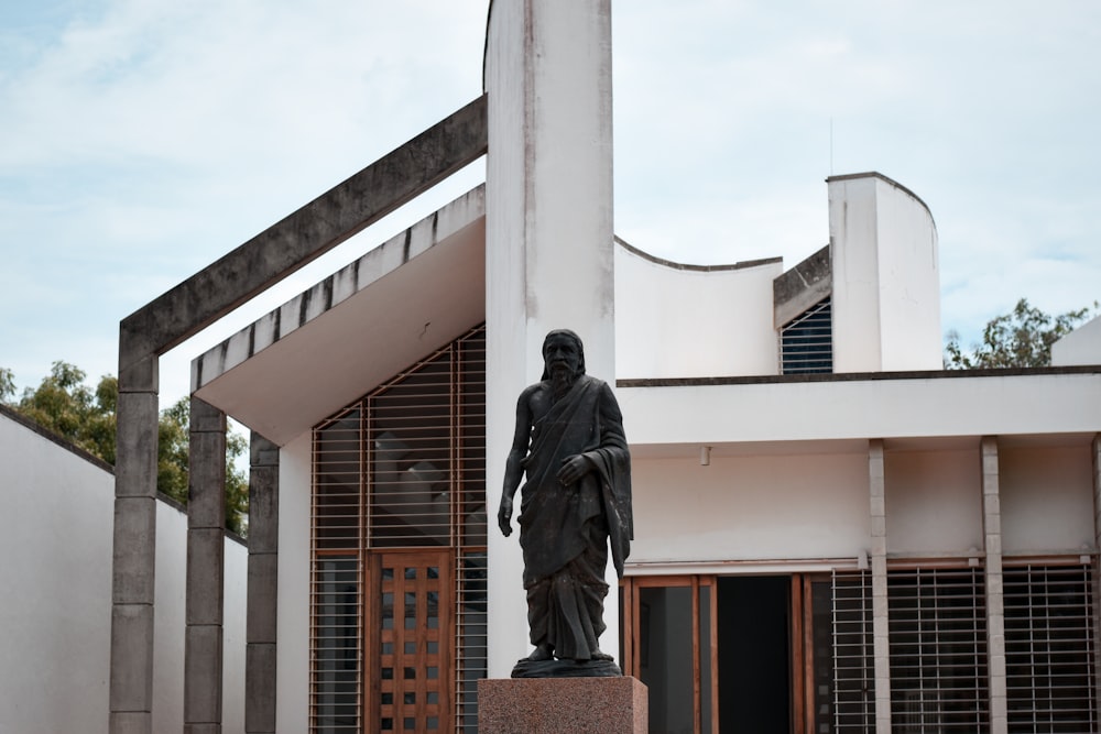 a statue of a man in front of a building