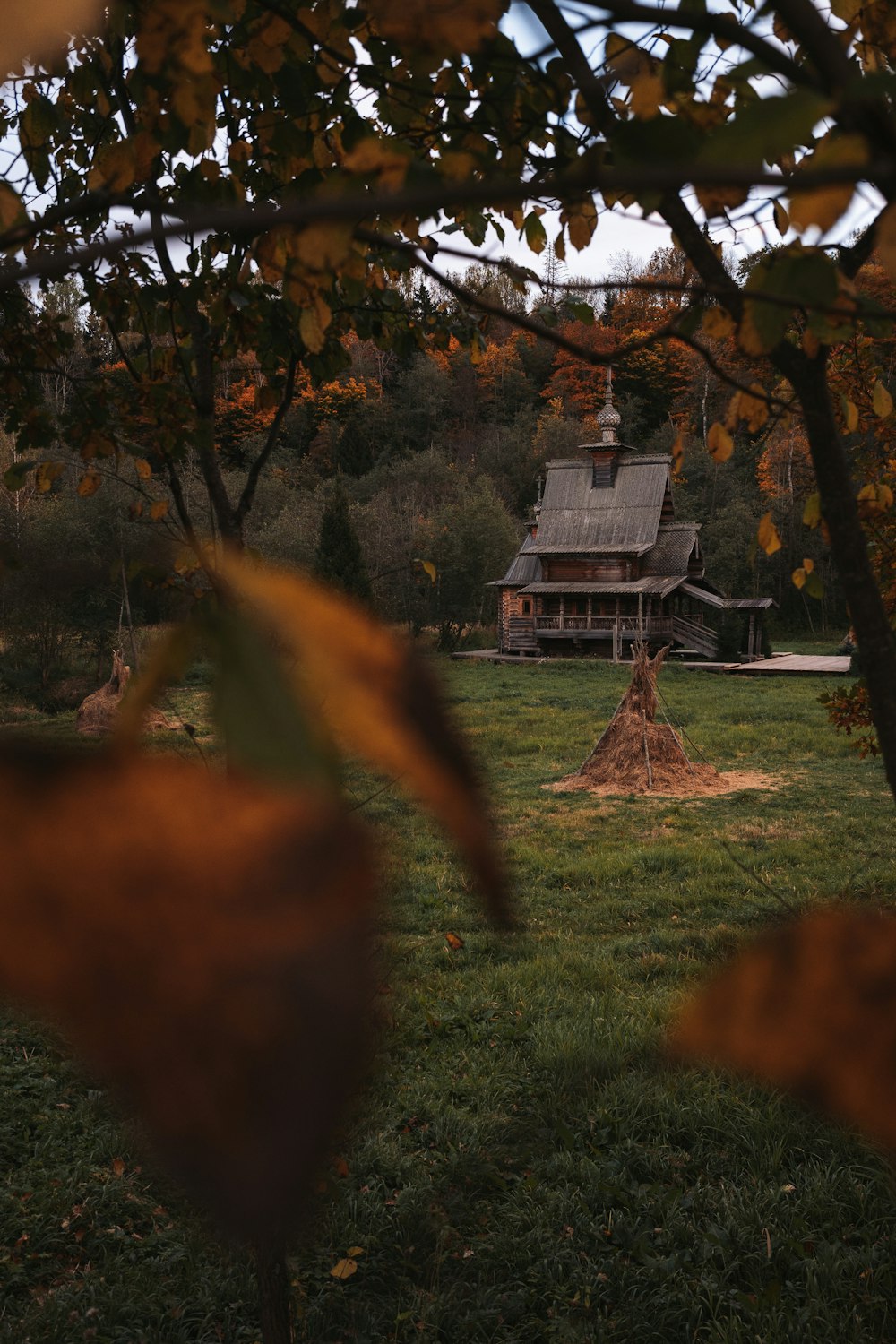 a house in the distance with trees in the foreground