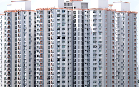 A cluster of durable labor accommodation units arranged neatly on a construction site in Qatar.