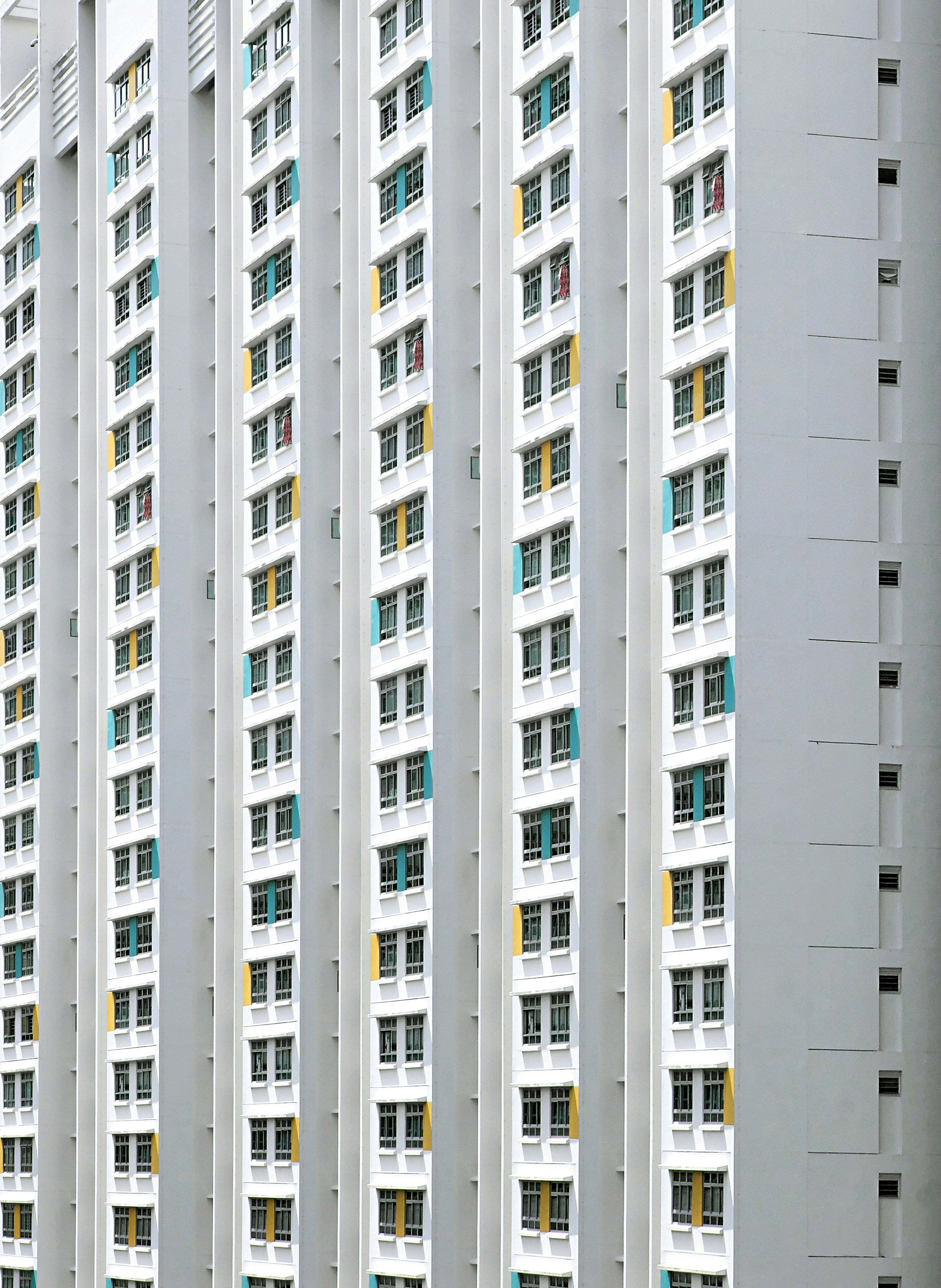 a very tall white building with lots of windows