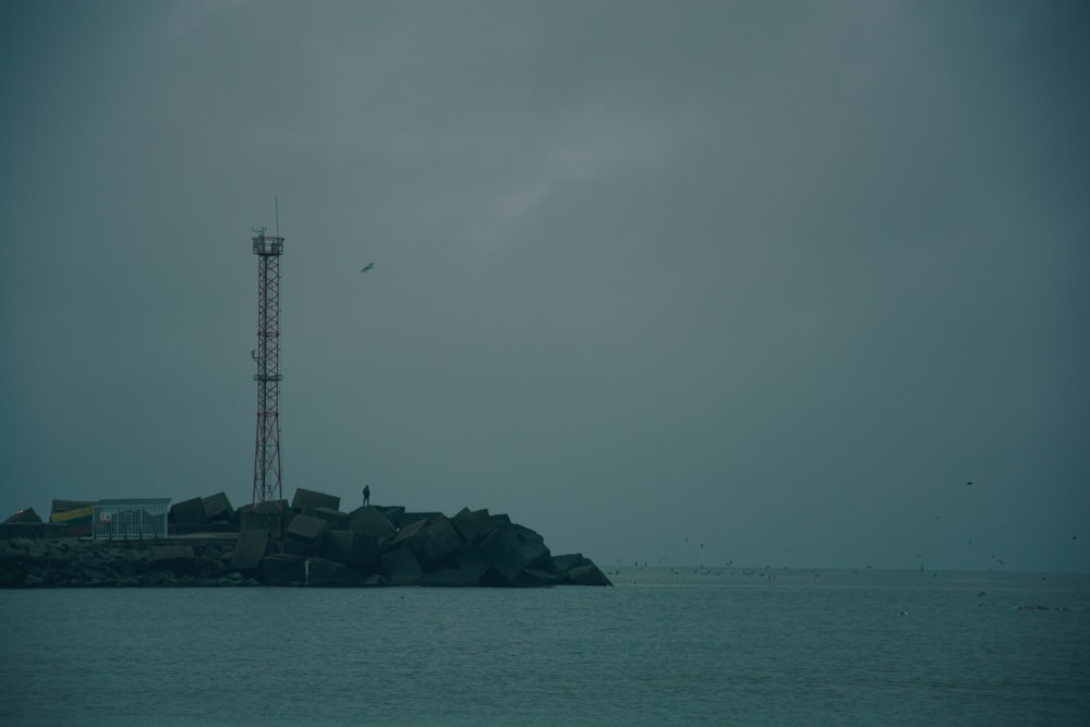 a tower on a small island in the middle of the ocean