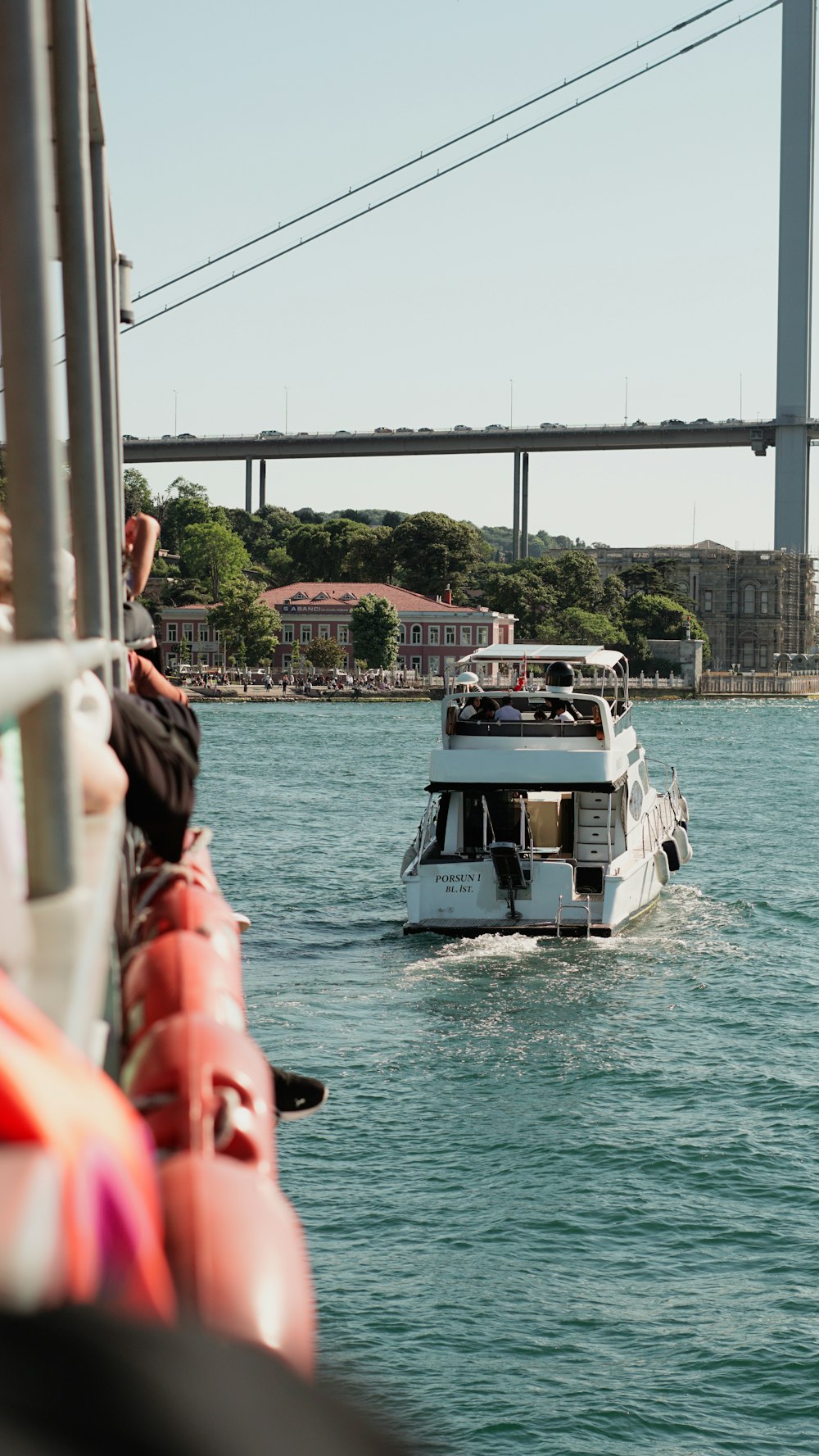 a boat traveling down a river next to a bridge