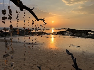 A luxury beach bungalow decorated with seashell art and sunset orange accents.