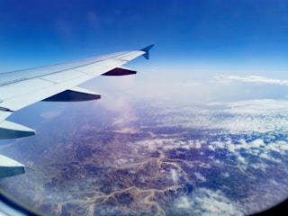 A scenic view of an airplane flying over a beautiful landscape.