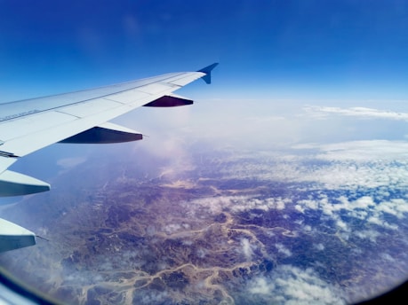 A scenic view of an airplane flying over a beautiful landscape.