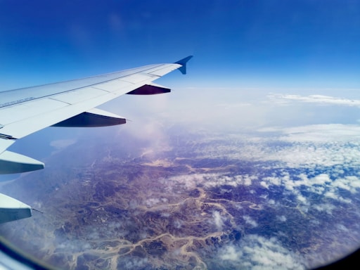 A scenic view of an airplane flying over a beautiful landscape.