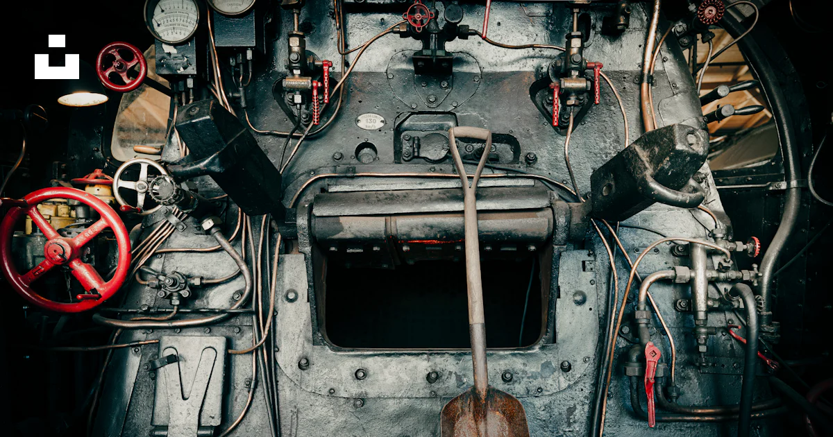 The inside of a large metal machine with many wires and gauges photo ...