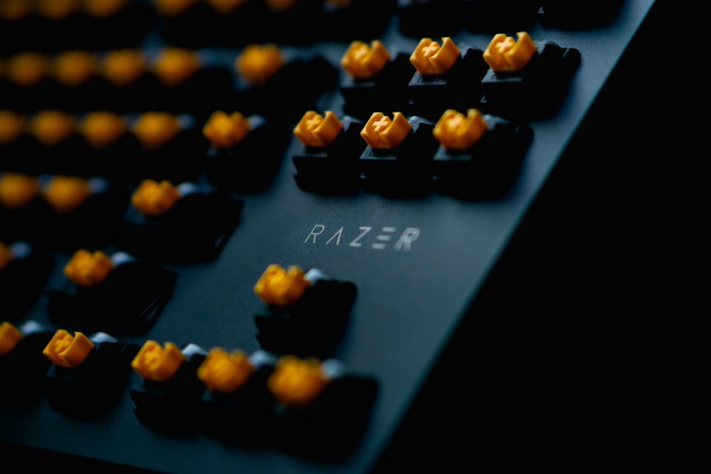a close up of a keyboard with yellow knobs