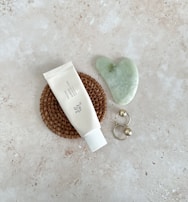 Flat lay of zentic wellness collection pieces on a cream background with teal details.