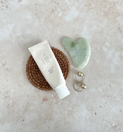 Elegant flat lay of Nouréa Cream with soft gold accents and Moroccan geometric patterns.