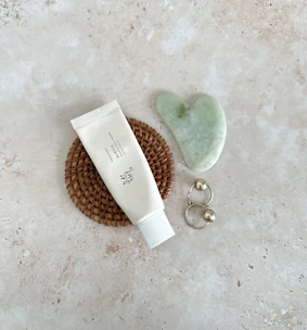 Elegant flat lay of Nouréa Cream with soft gold accents and Moroccan geometric patterns.