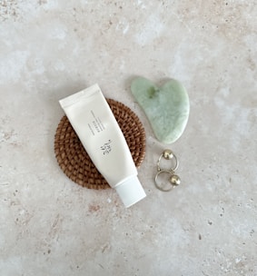 A serene flat lay of spiritual jewelry on soft pastel fabric