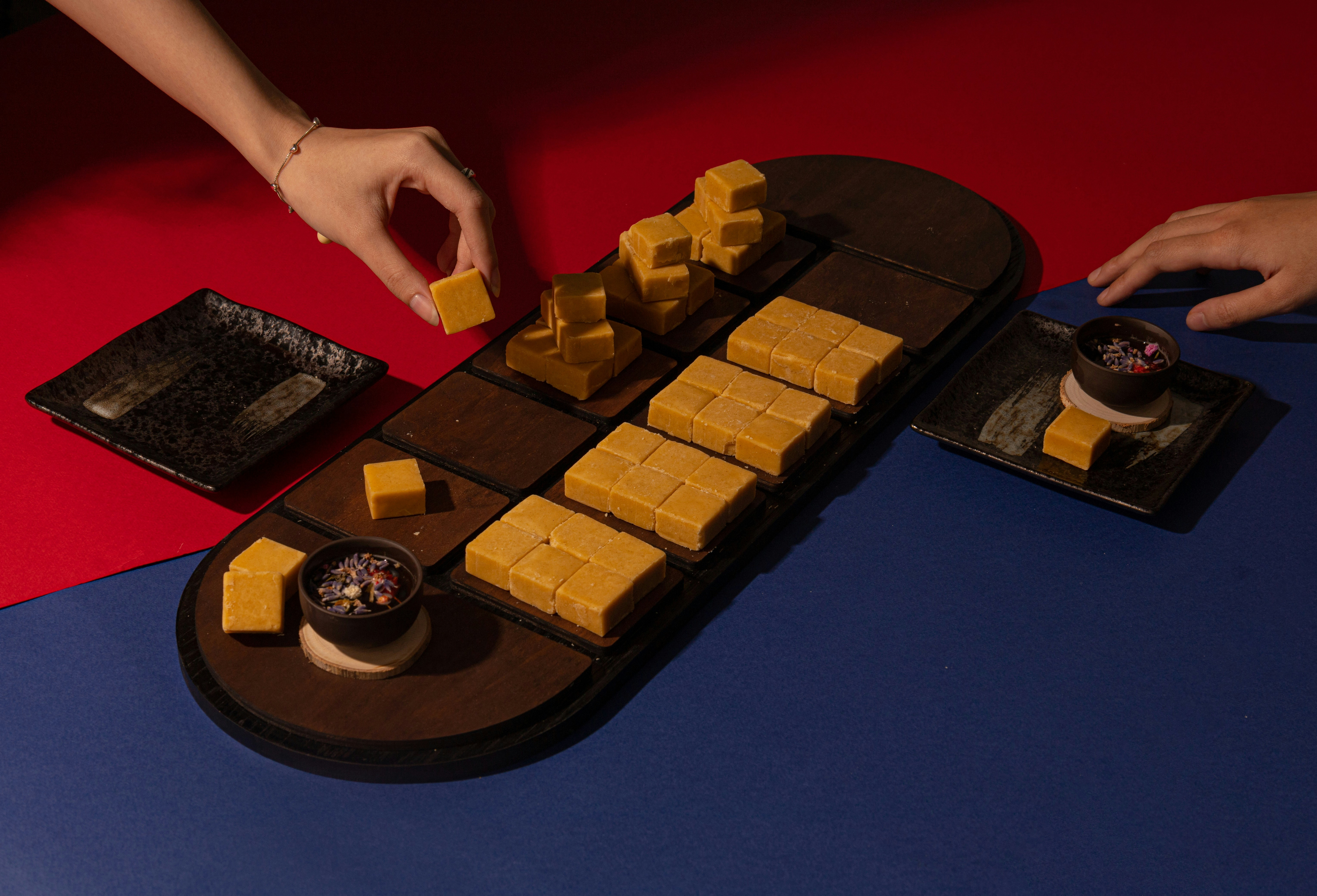 a person reaching for some food on a tray