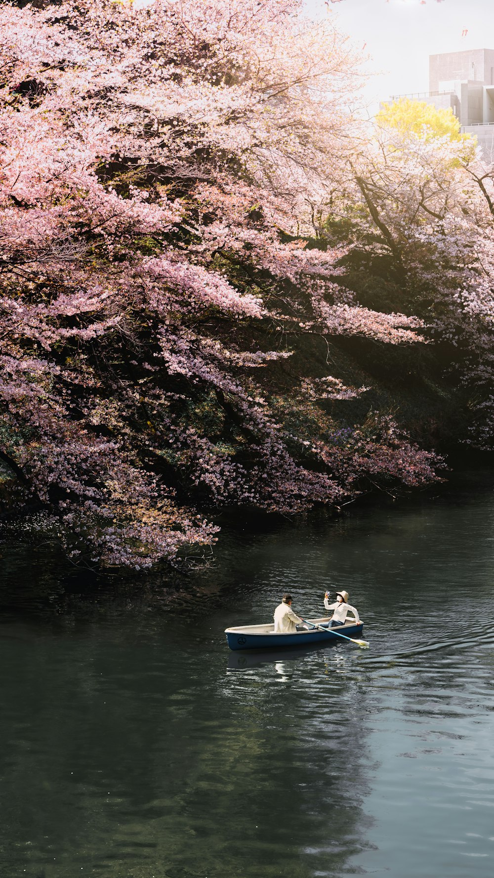 two people in a small boat on a river