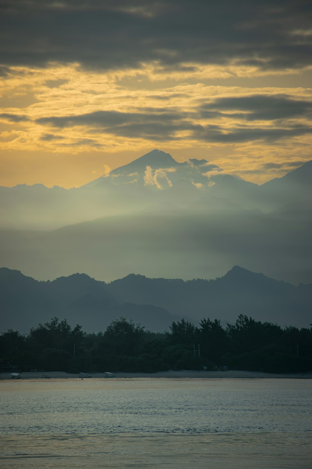 a large body of water with a mountain in the background