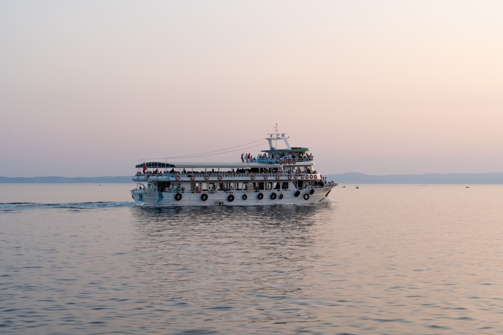 a large boat filled with people on top of a body of water