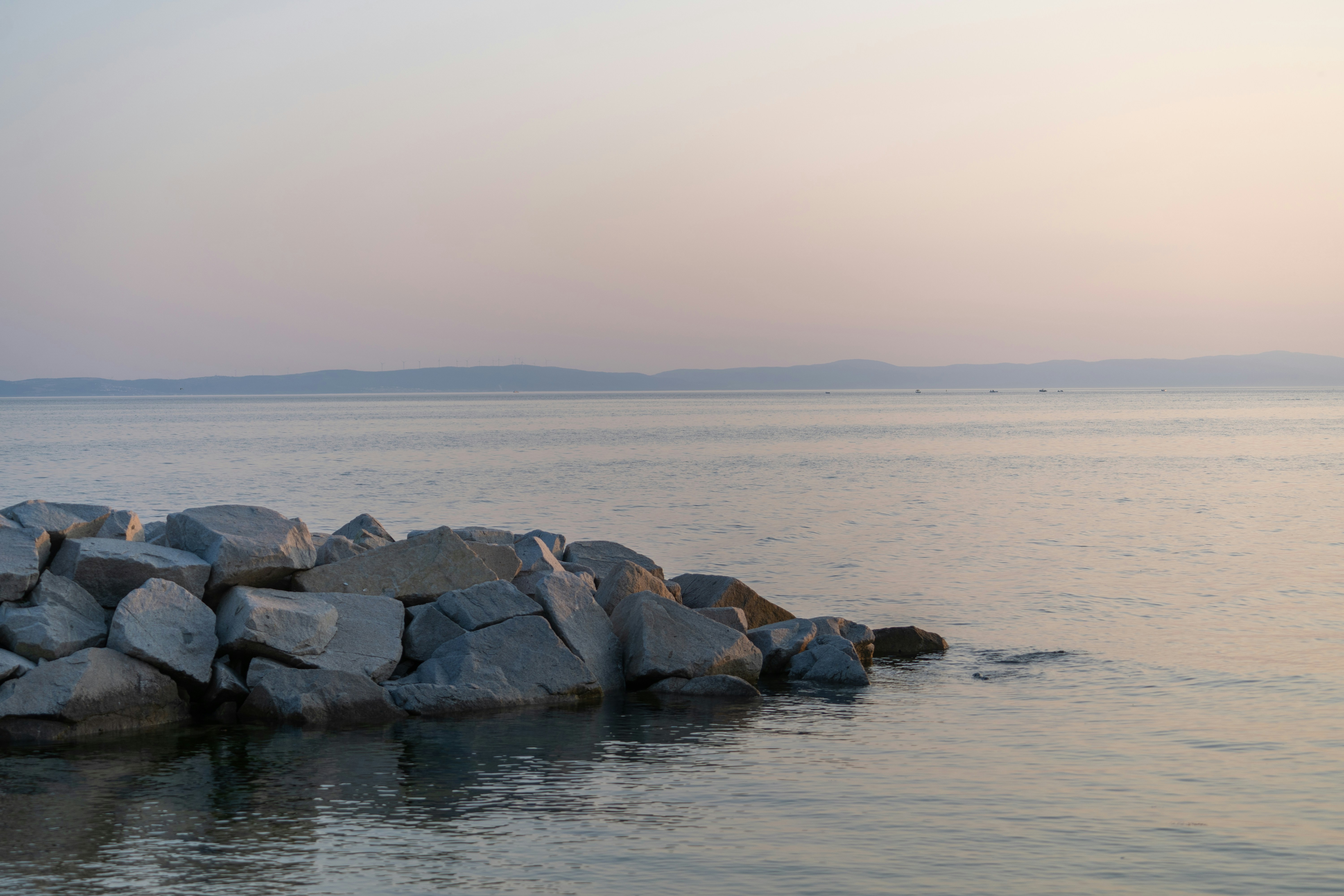 a large body of water surrounded by rocks - a-large-body-of-water-surrounded-by-rocks-OUM6vA26WJA