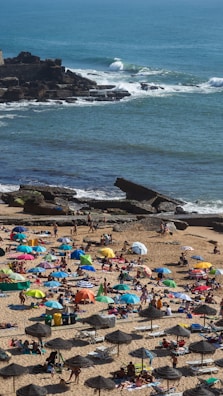 A lively beachfront scene in Mazatlán with colorful umbrellas and people enjoying the sun.