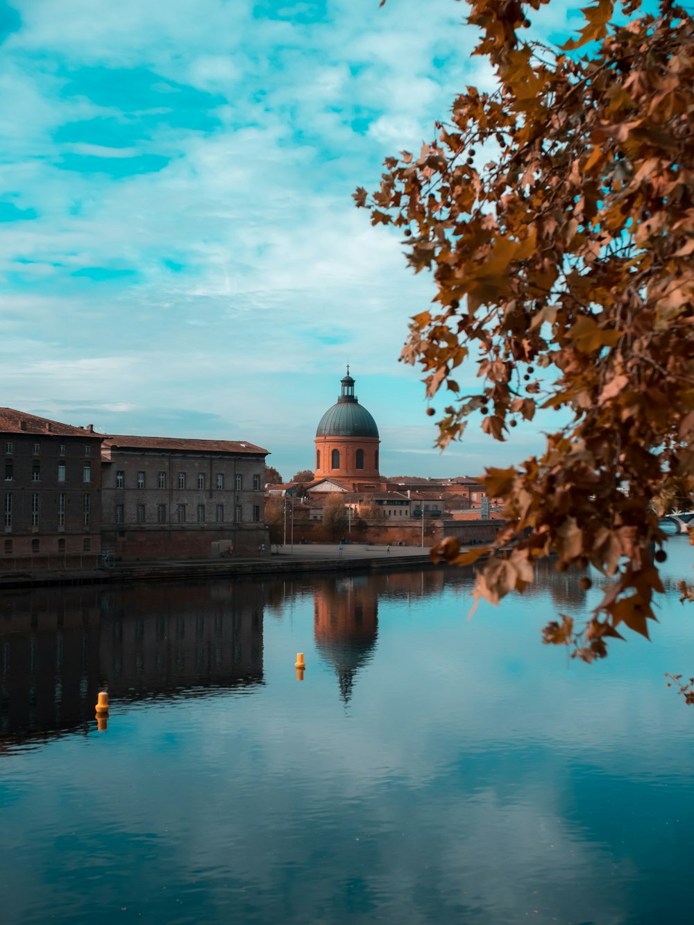 a body of water with a building in the background