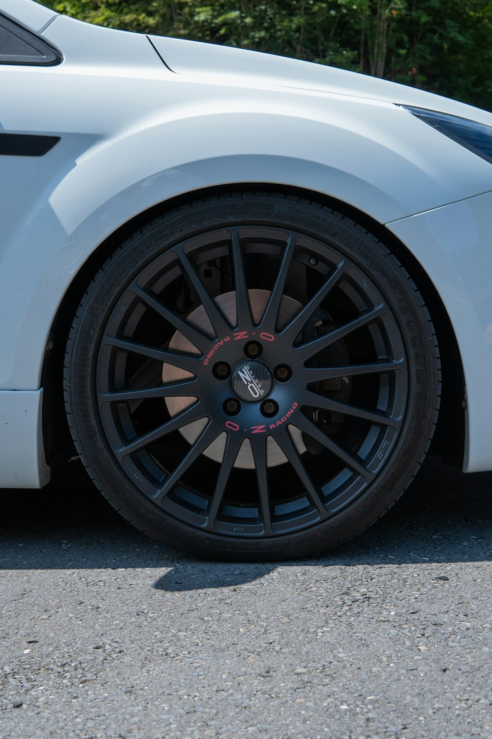 a close up of a car tire on a street