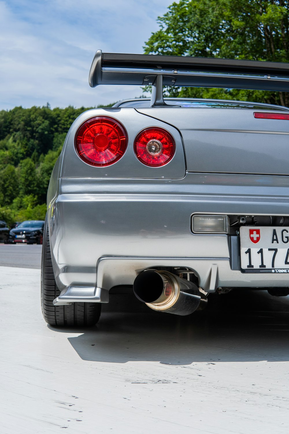 a silver sports car parked in a parking lot