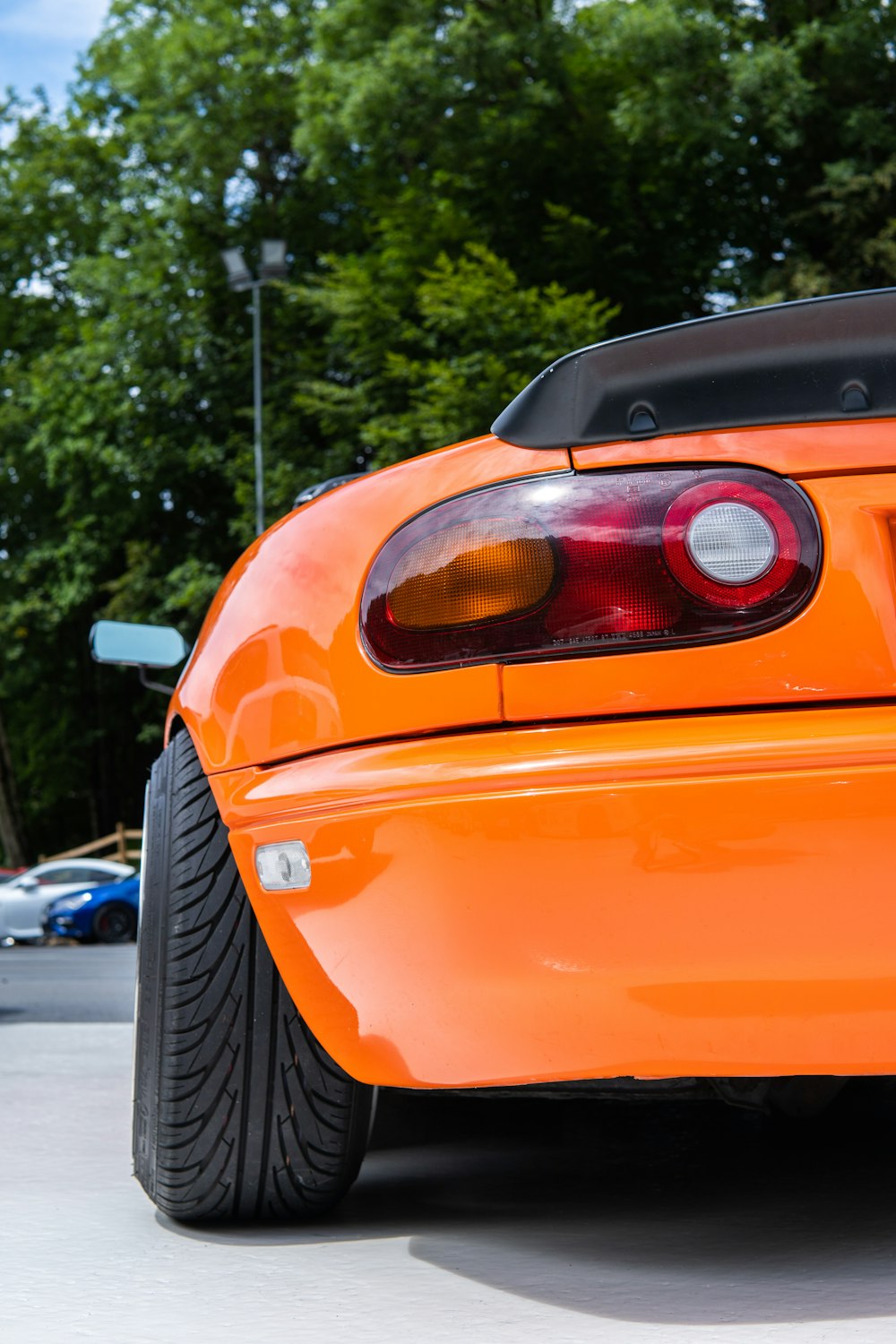 an orange sports car parked in a parking lot