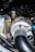 A close-up view of a turbocharger system in an engine bay, featuring metallic tubes and pipes wrapped in heat-resistant material, with the BorgWarner logo visible. The components have a mix of polished and textured surfaces.