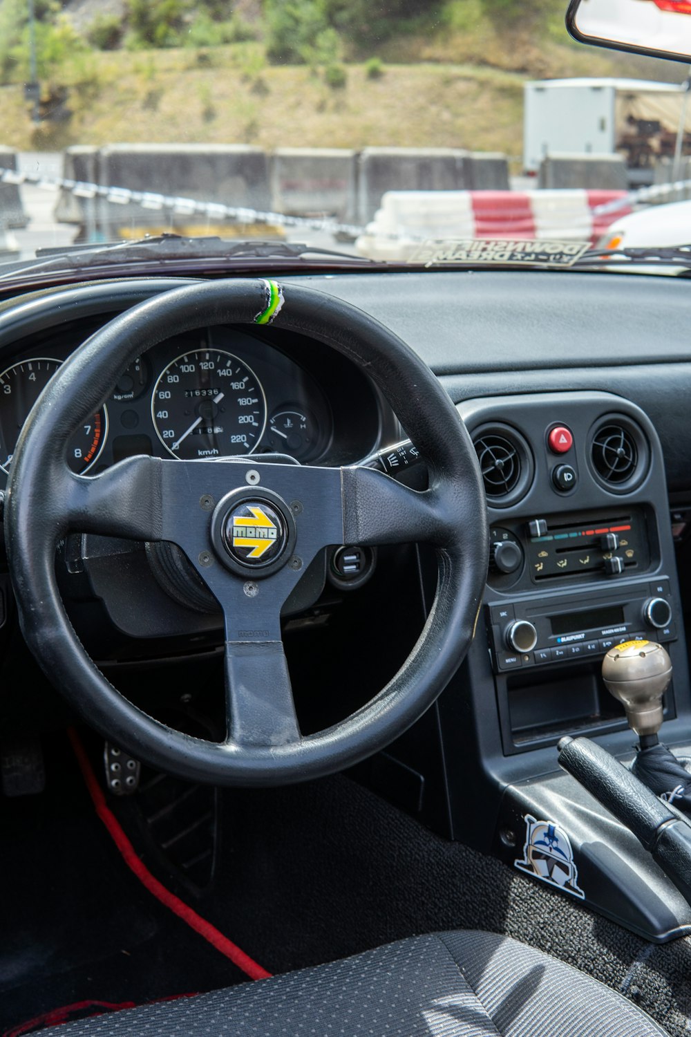 a dashboard of a car with a steering wheel