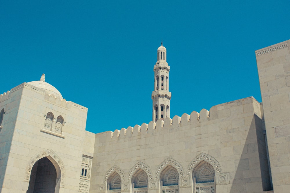 a tall white building with a clock on it's side