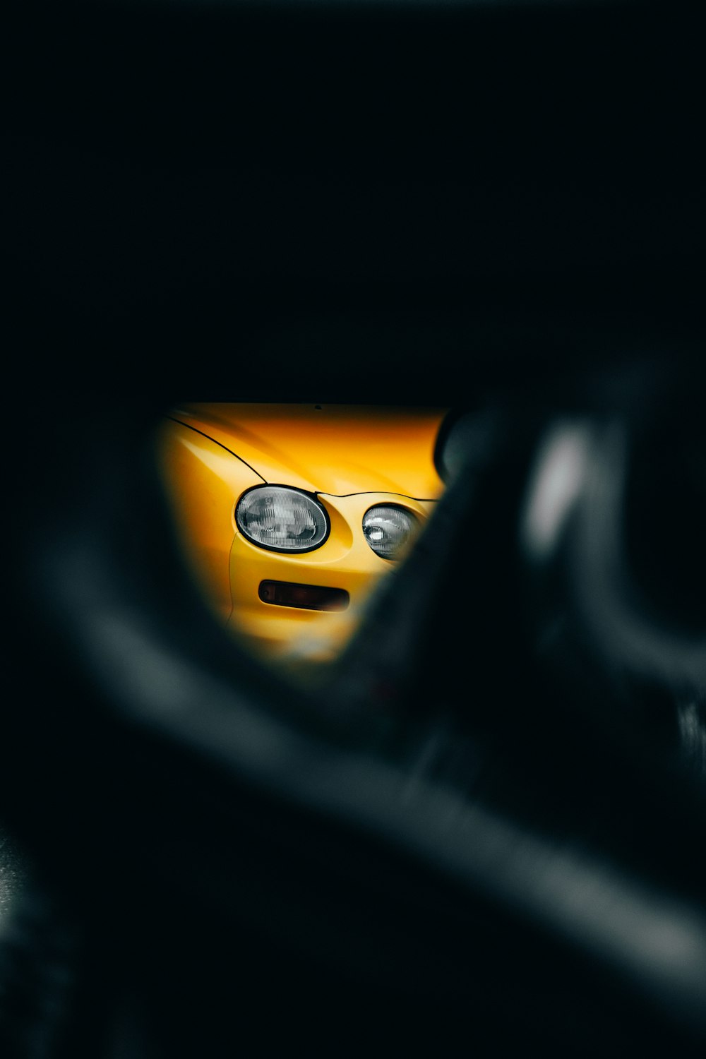 a close up of a yellow sports car