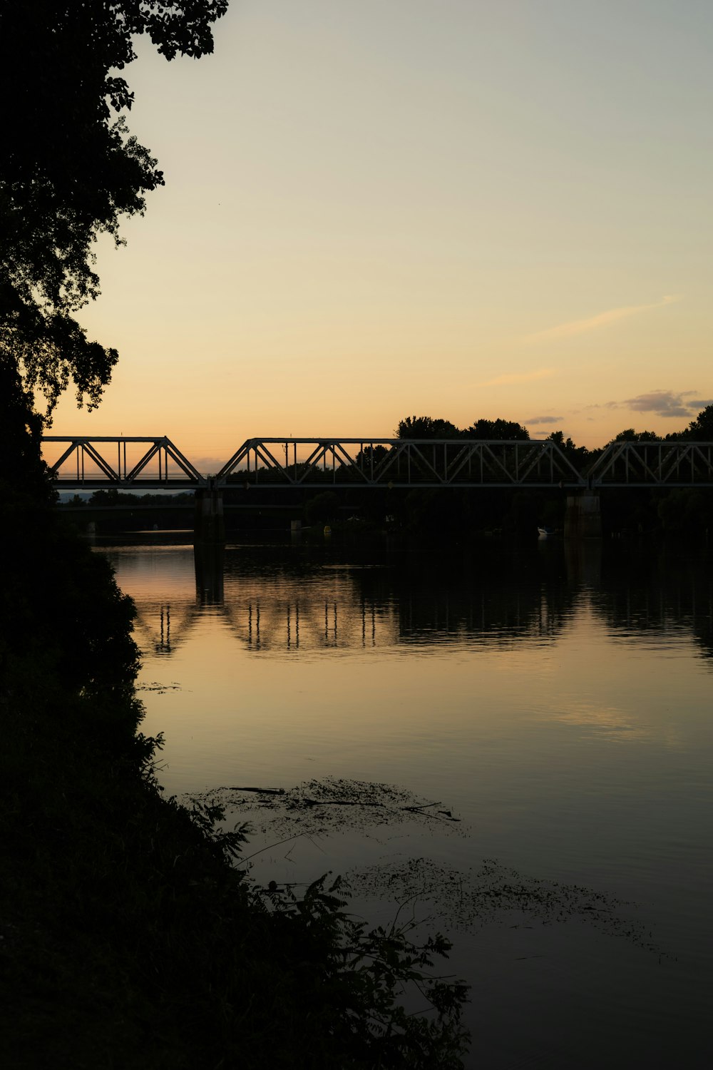 a bridge over a body of water at sunset