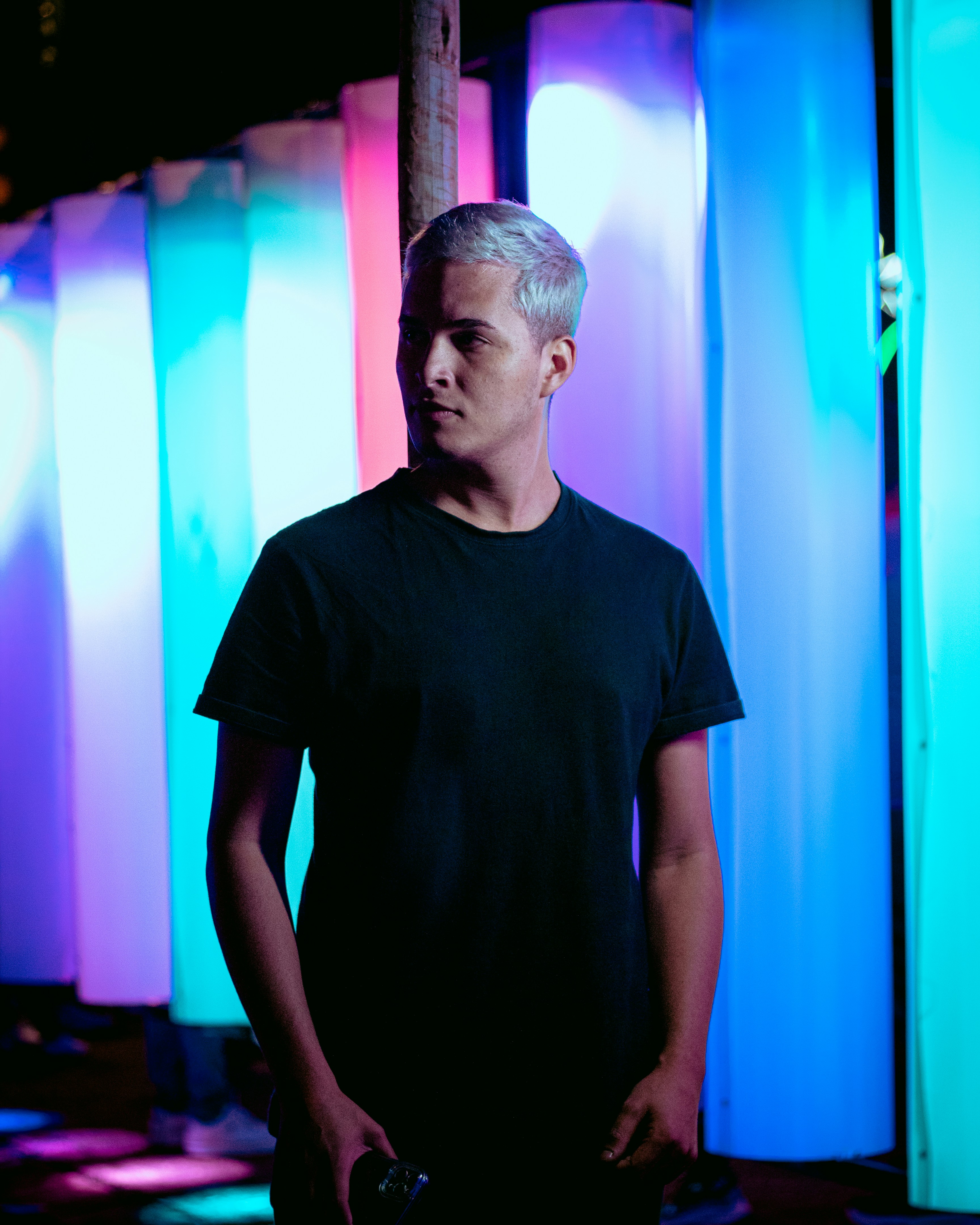 a man standing in front of a colorful wall