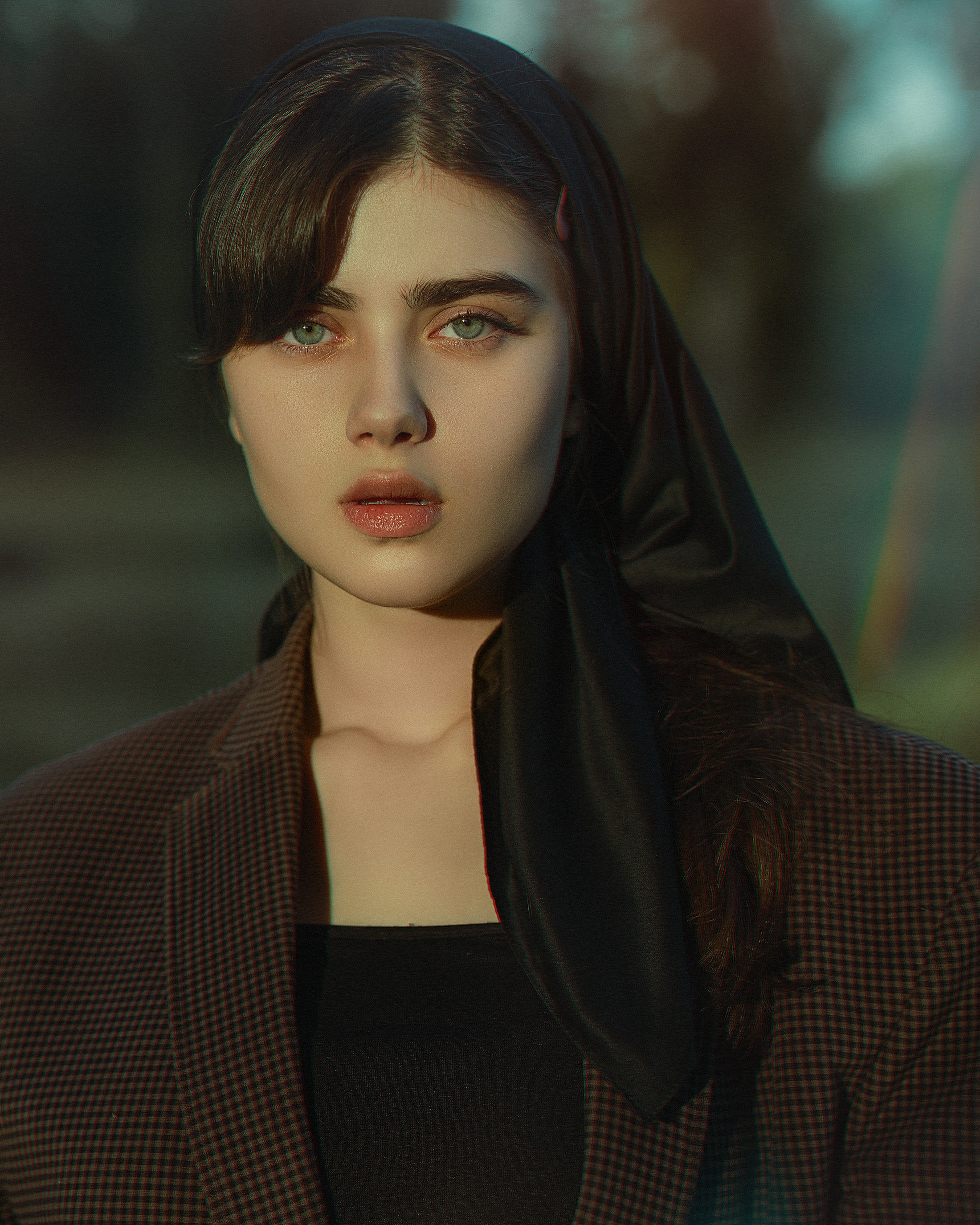 a woman with a black scarf on her head