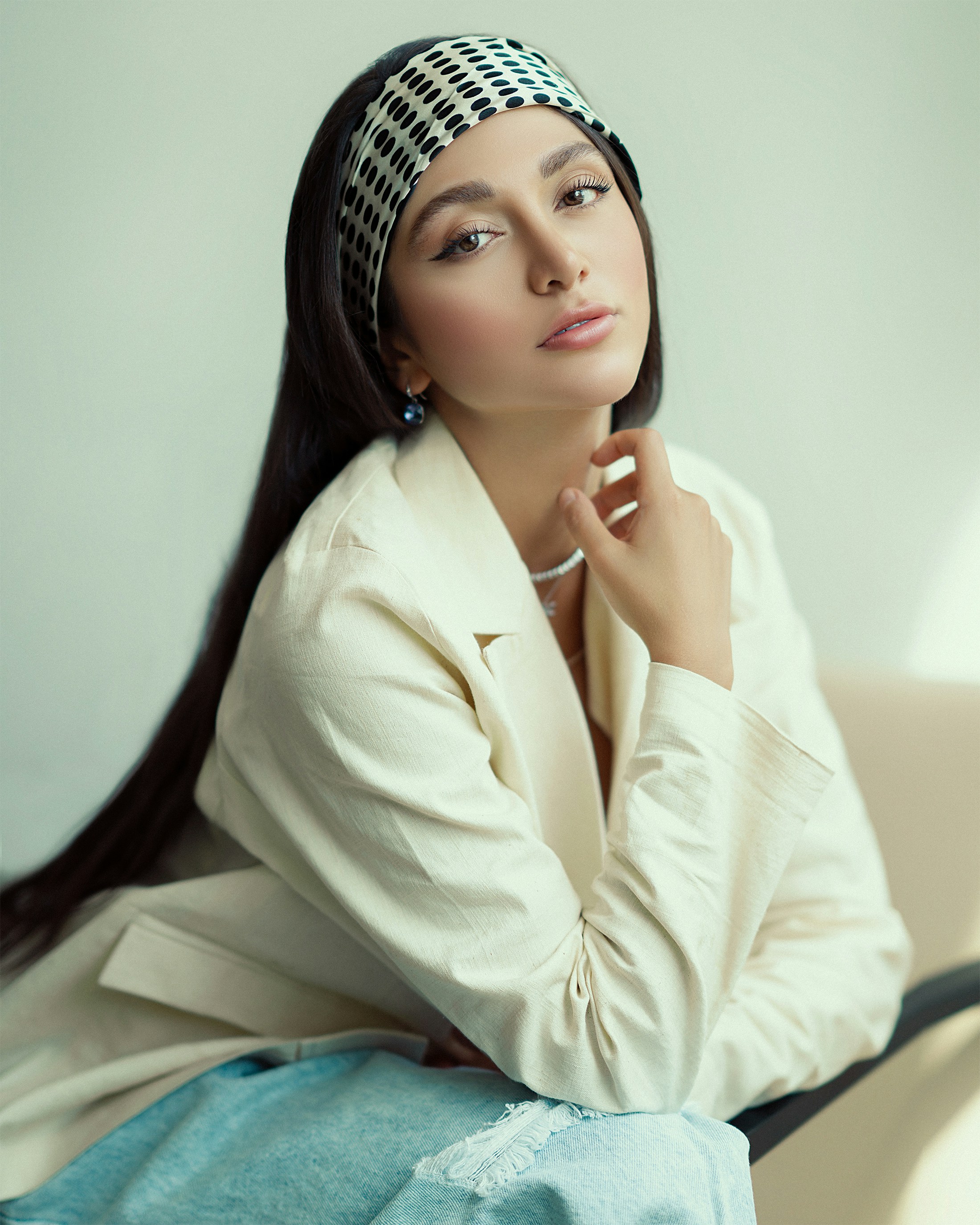 a woman with long hair sitting on a couch