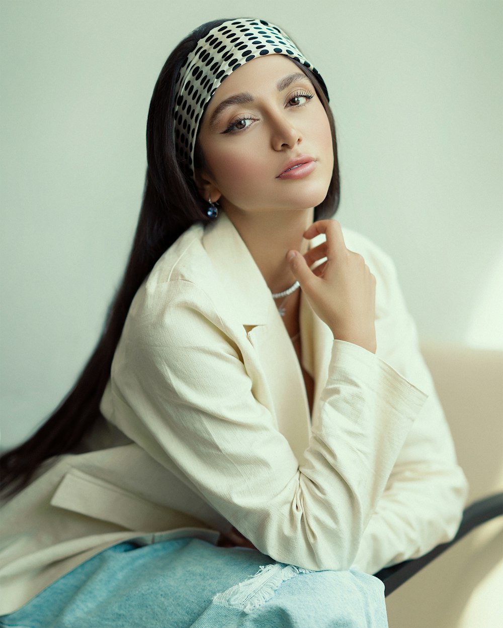 a woman with long hair sitting on a couch