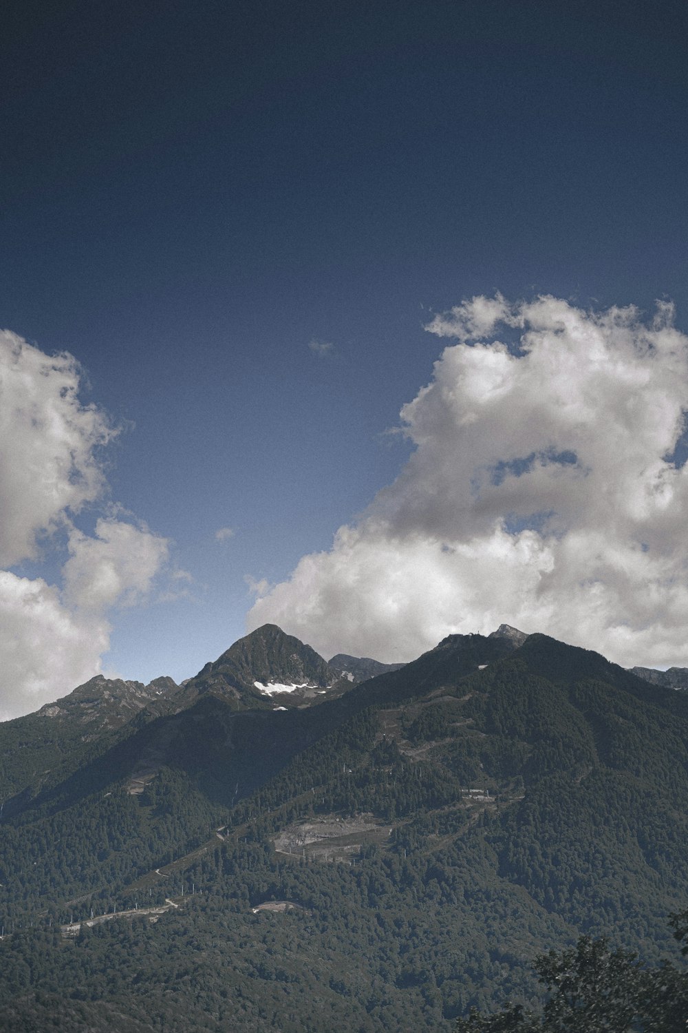 a view of a mountain with clouds in the sky