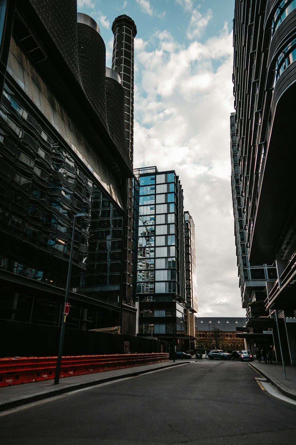 a city street with tall buildings next to each other