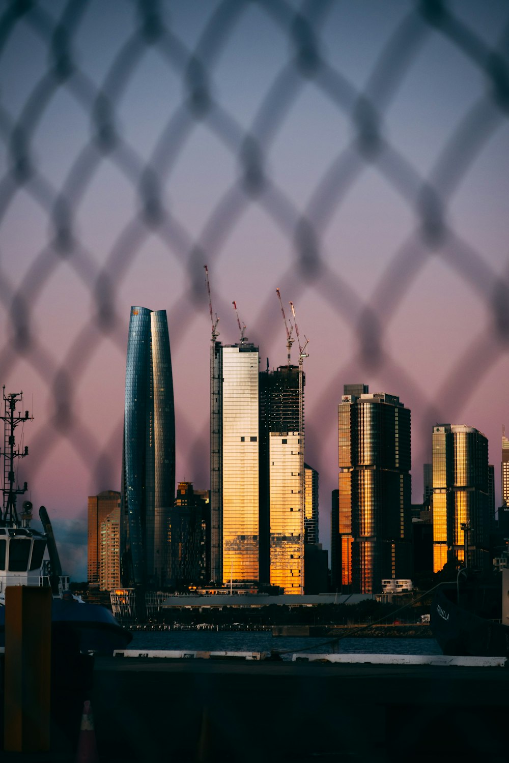 a view of a city through a fence