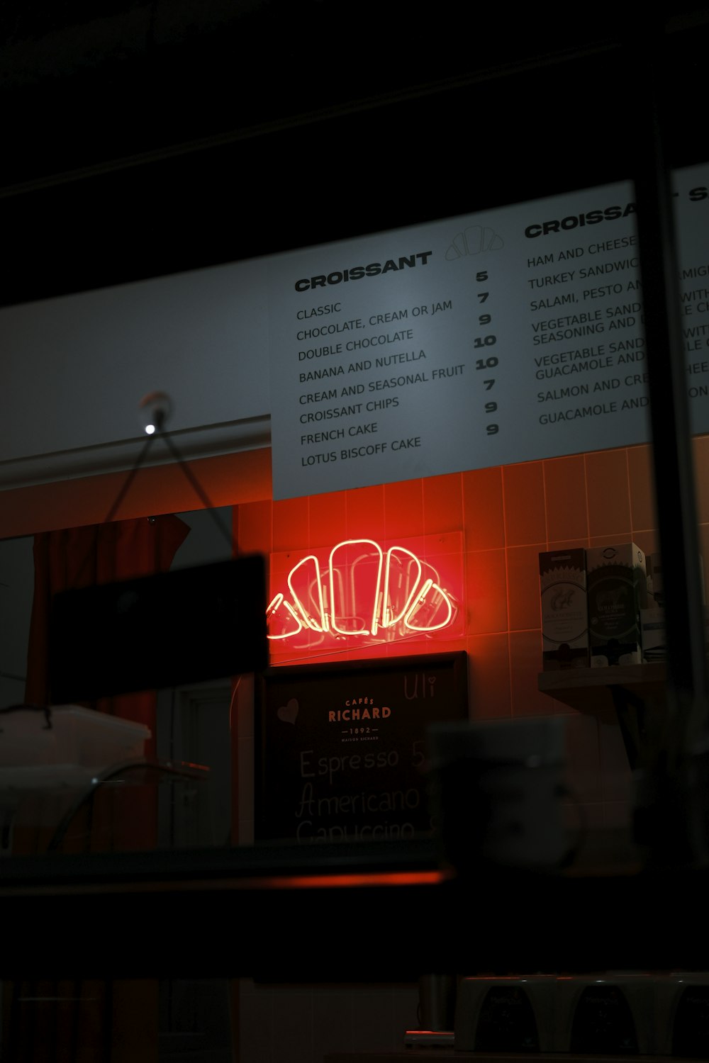 a restaurant sign is lit up in the dark